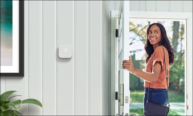 Amazon thermostat on white wall near door