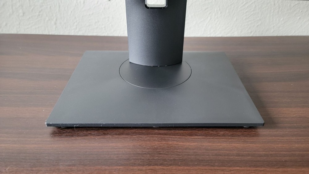 monoprice monitor base showing where it can swivel and where you can filter cords through