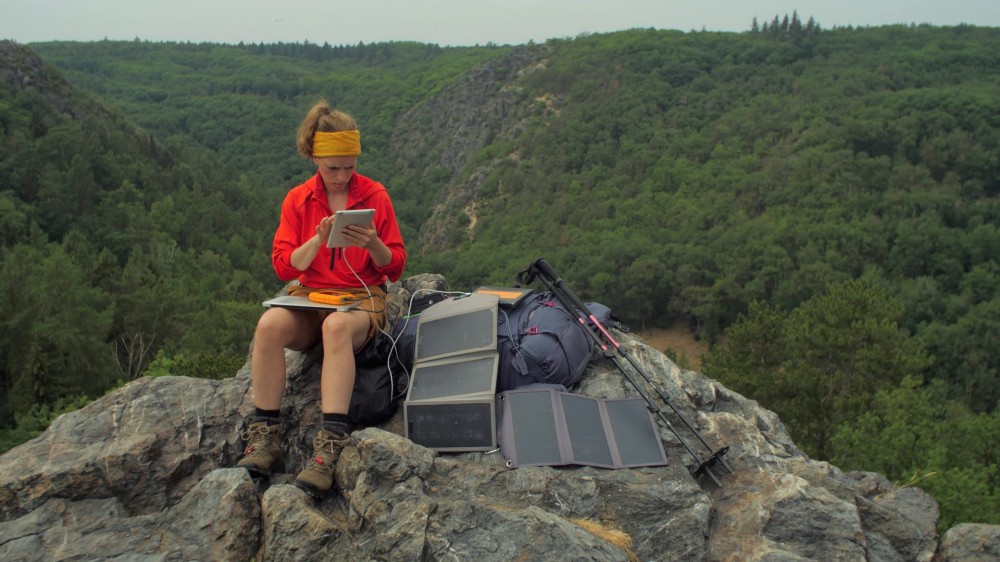 female hiker using a solar charger