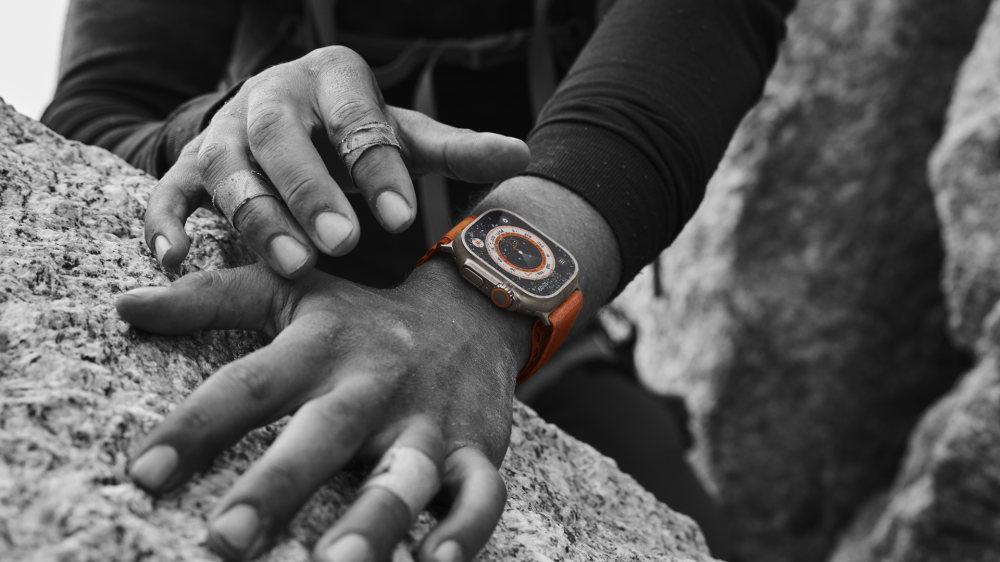 A person rock climbing while wearing an Apple Watch Ultra