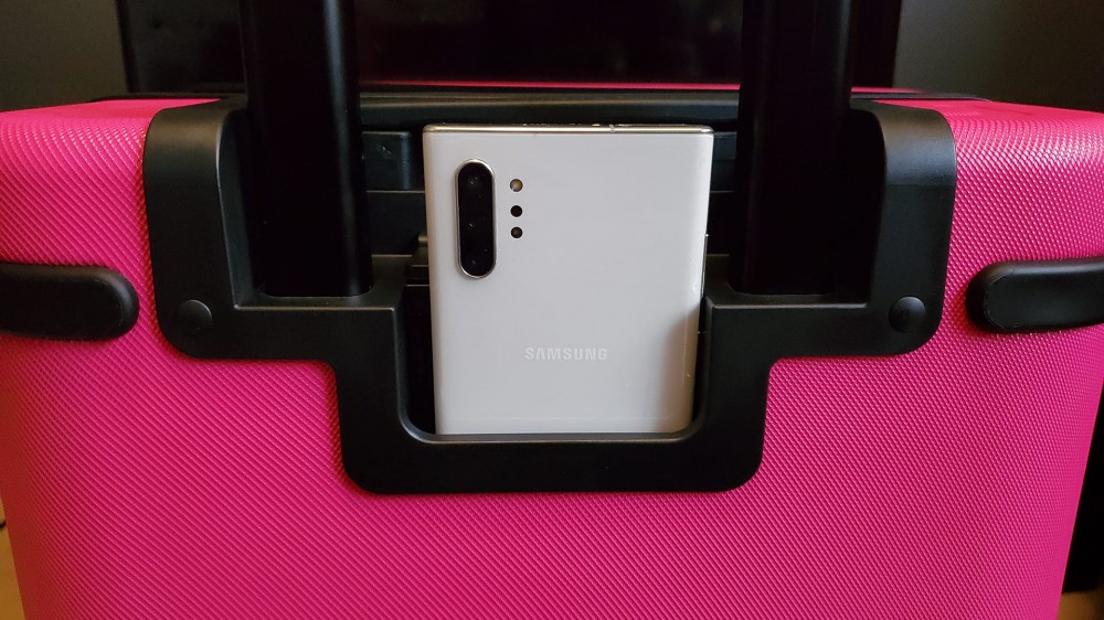 The T-Mobile Samsara Un-carrier On smart suitcase with a caseless phone in the holder.