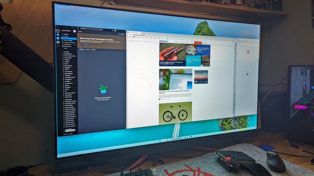 A gaming monitor with several browser and app windows open